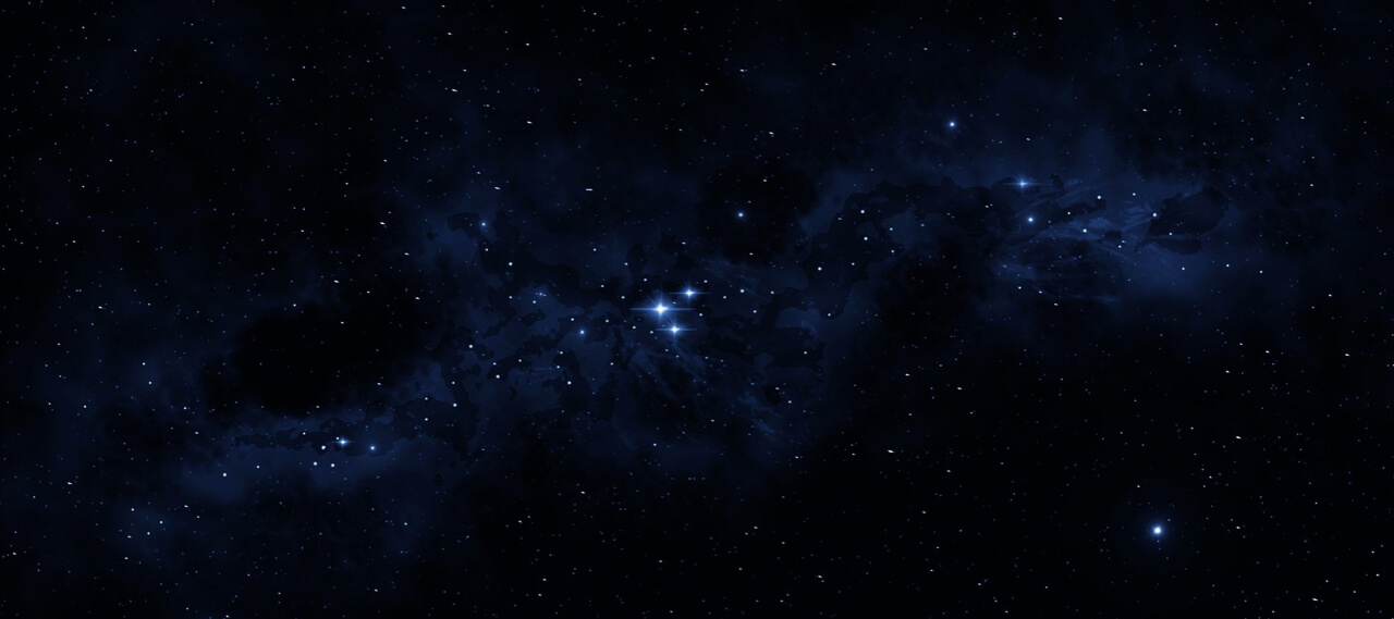 Dark, starry expanse of the night sky with a light nebula running through the center